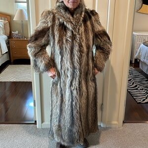 Raccoon fur coat with high collar.  Long with hook closures.